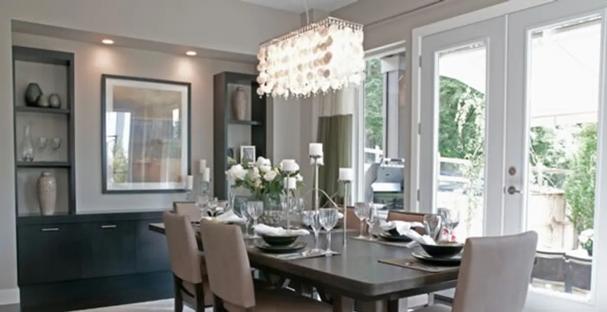 Elegant dining room chandelier installation above table in Orlando, FL