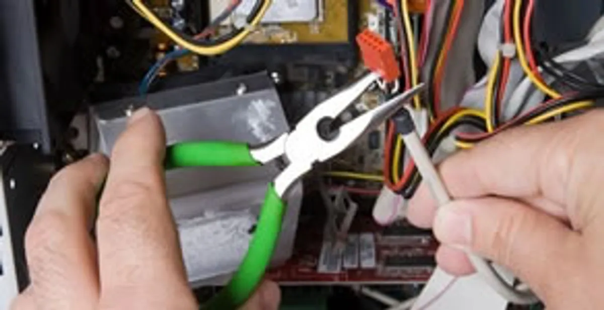 Licensed electrical contractor performing electrical repair with tools in Winter Garden, FL